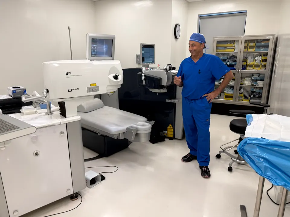 Rajesh Khanna, MD in blue scrubs in the laser suite